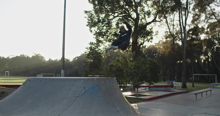 A man does skate tricks at a skate park