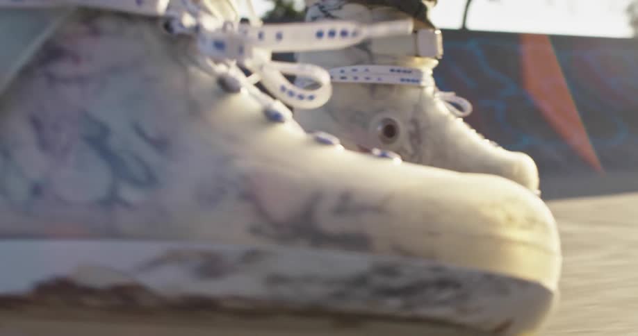 Man skating in rollerblades on a skate park at sunset