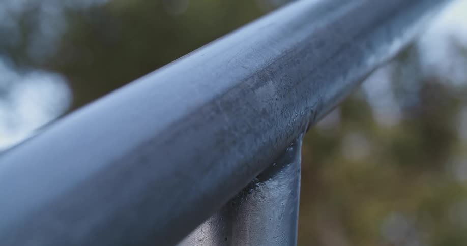 A view of a metal handrail at a park