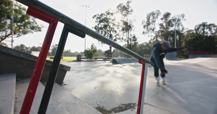 A man is rollerblading at a public park in spring