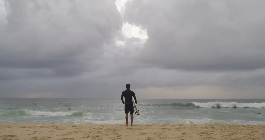 Man standing looking at ocean