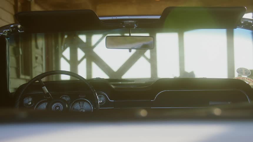 A car is parked in a garage at dusk