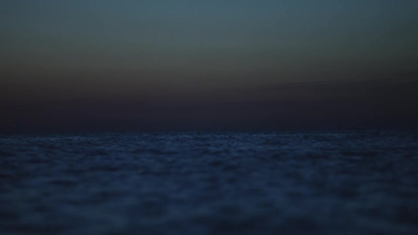Rough ocean water under a night sky
