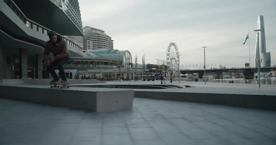 A man skateboards at a city waterfront park
