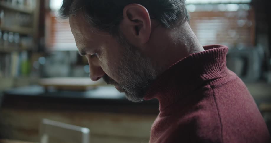 A portrait of a man in a turtleneck sweater