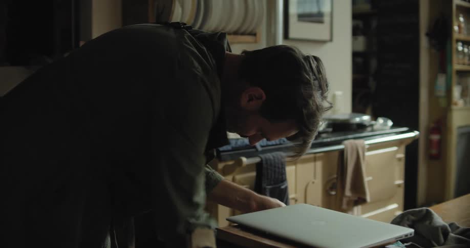 Nervous man hurriedly searching for something while packing at home