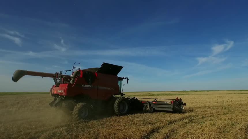 A piece of farm equipment performing its craft in a field