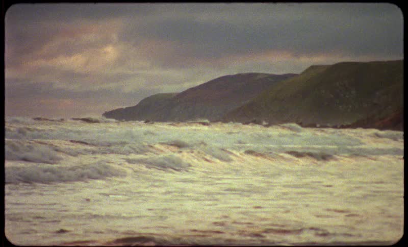 Ocean waves moving in rapidly on a shoreline
