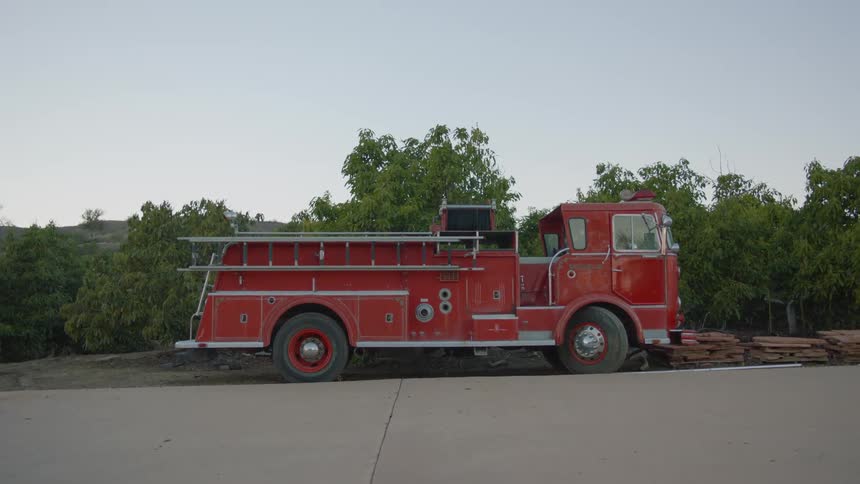 A red fire truck parked outside during the day