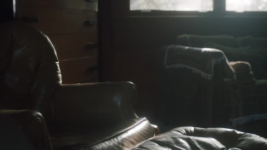 Chairs sitting in a home as the sun shines through the window