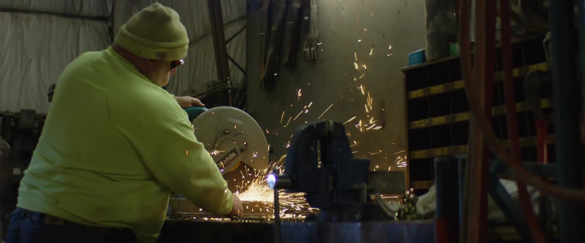 An employee is working in a machine shop