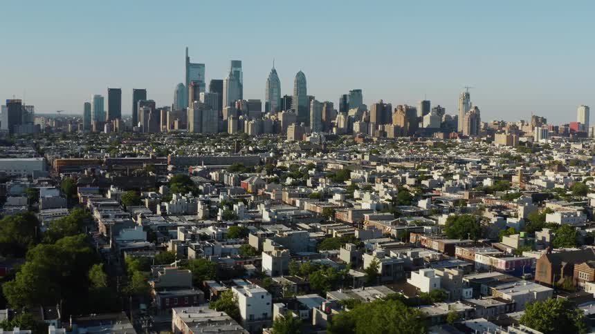 Aerial view of a large city with a tower block and surrounding neighborhoods at daytime