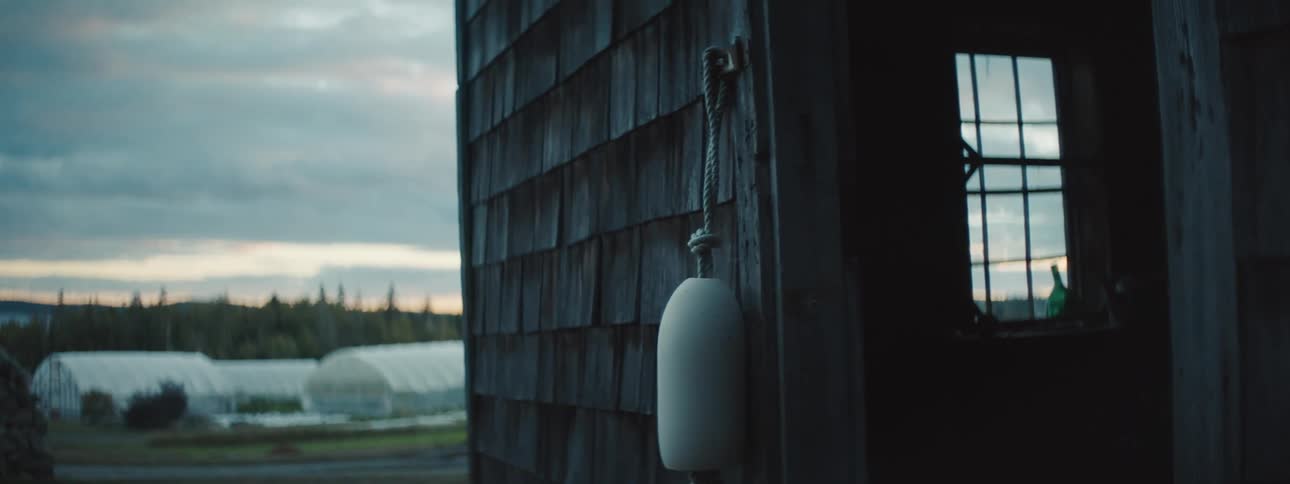 A barn is in a rural area at dusk
