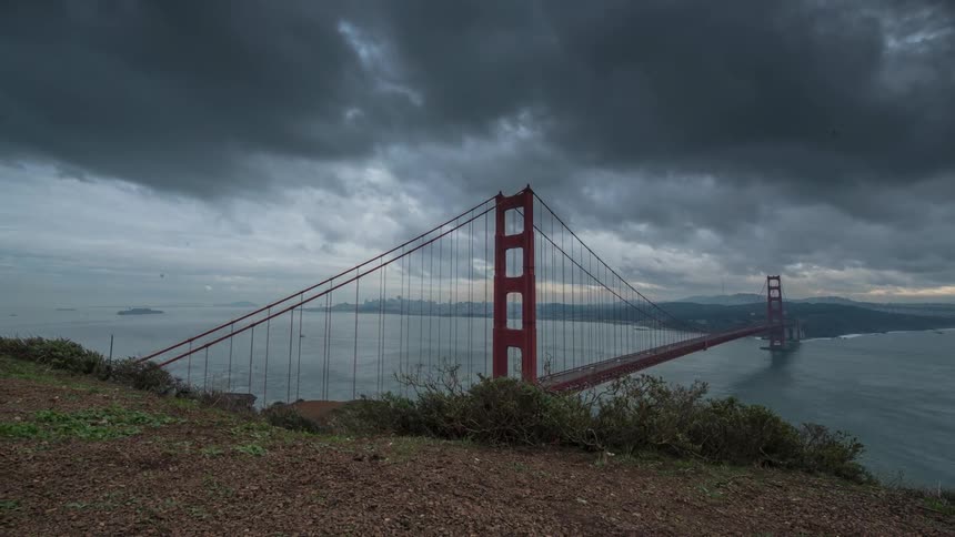 Thick clouds flowing over the golden gate bridge