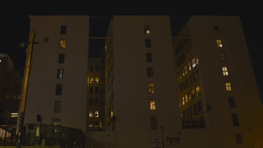 A group of buildings connected by bridges at night