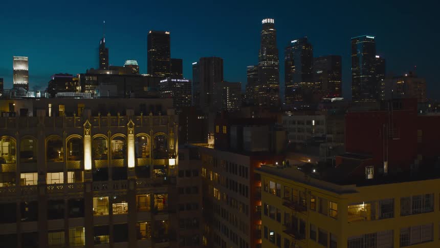 Apartment buildings in a city with the skyline behind them