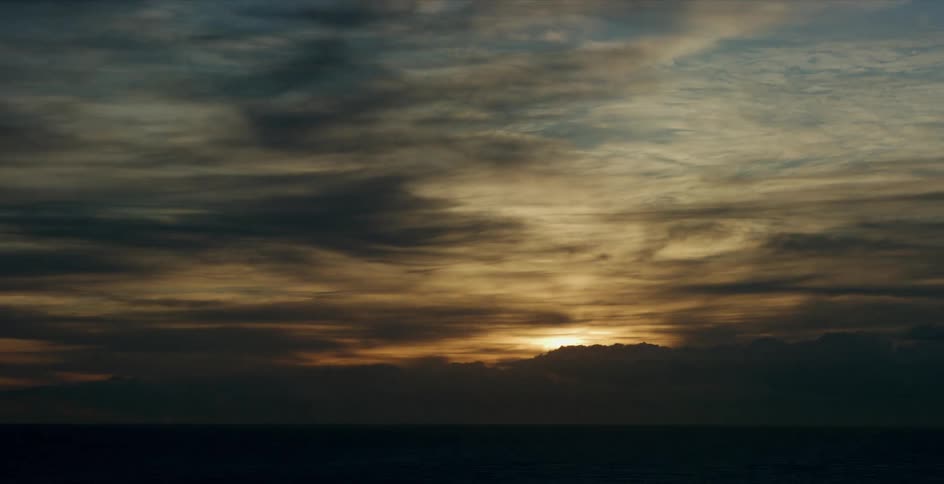 A view of the sun rising over some clouds