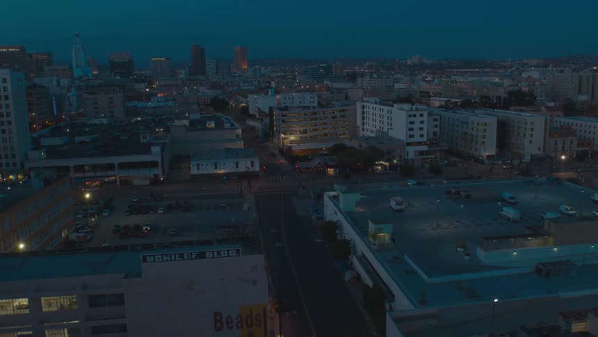 Vehicles fill the rooftop parking lot of downtown apartment buildings