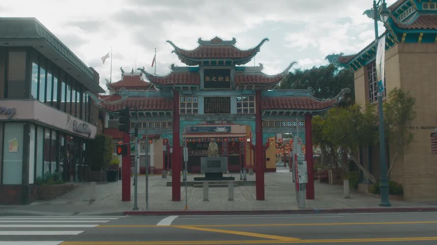 Cars drive on the road by the temple