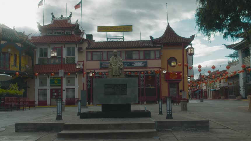 A look at an asian building with a statue out in front