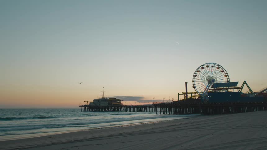 A carnival is by the beach at dusk