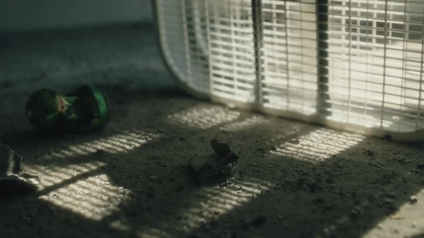 A fan on the floor in a room spinning