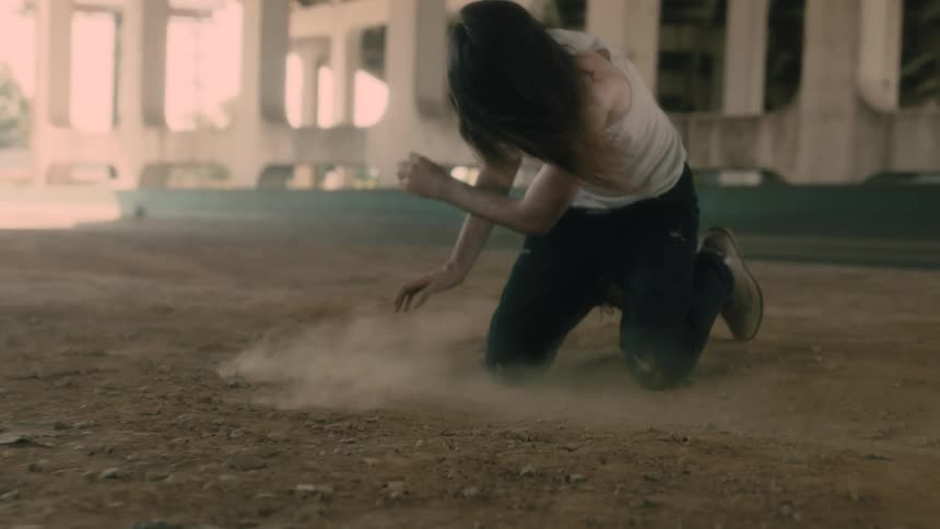 Man leaning over moving dirt