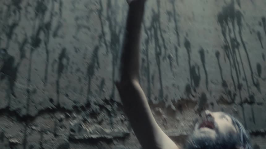 A man reaches up towards the light