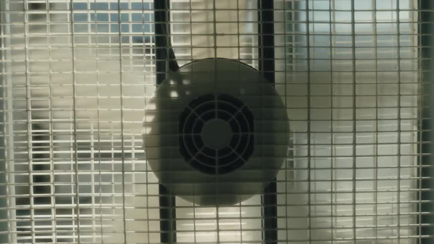 A fan is spinning in a room