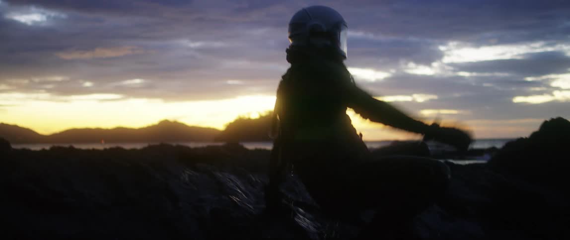 A person in a suit getting up and running into the forest