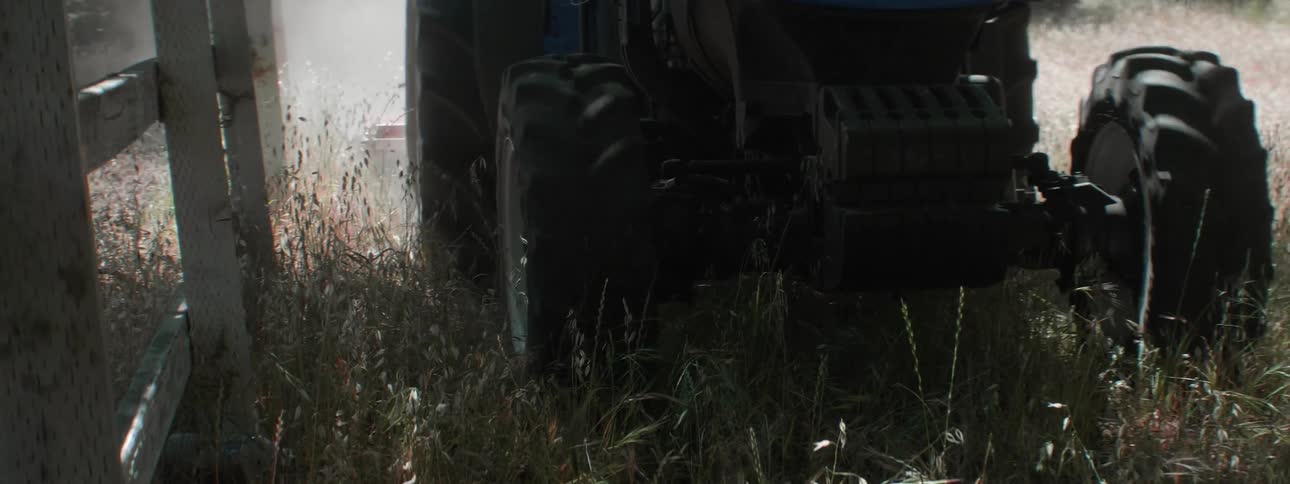 A person is riding a tractor on the farm