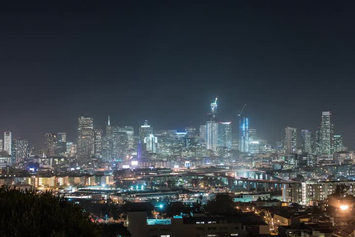 Time lapse of vehicles moving in a lit city at night