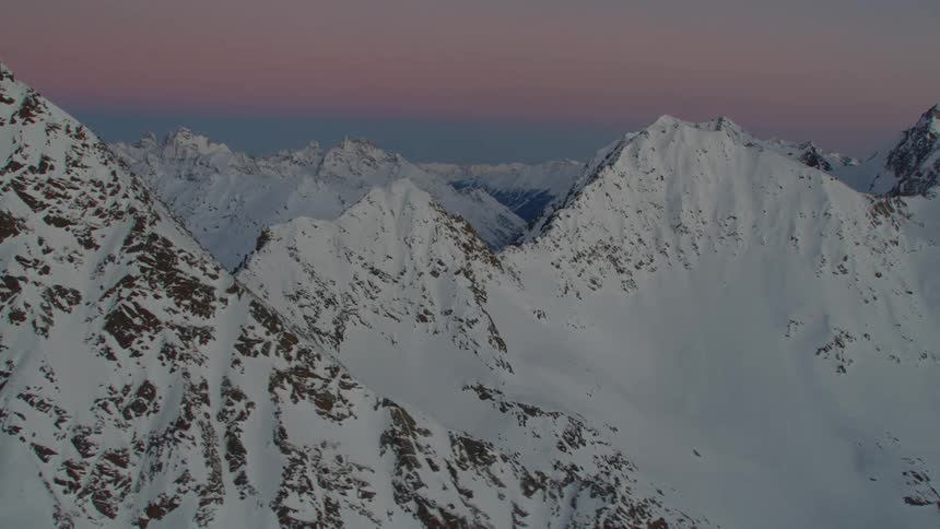 Flying over a mountain range at sunset