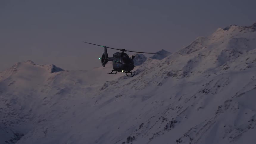 Tracking a helicopter flying at dusk over a mountain range
