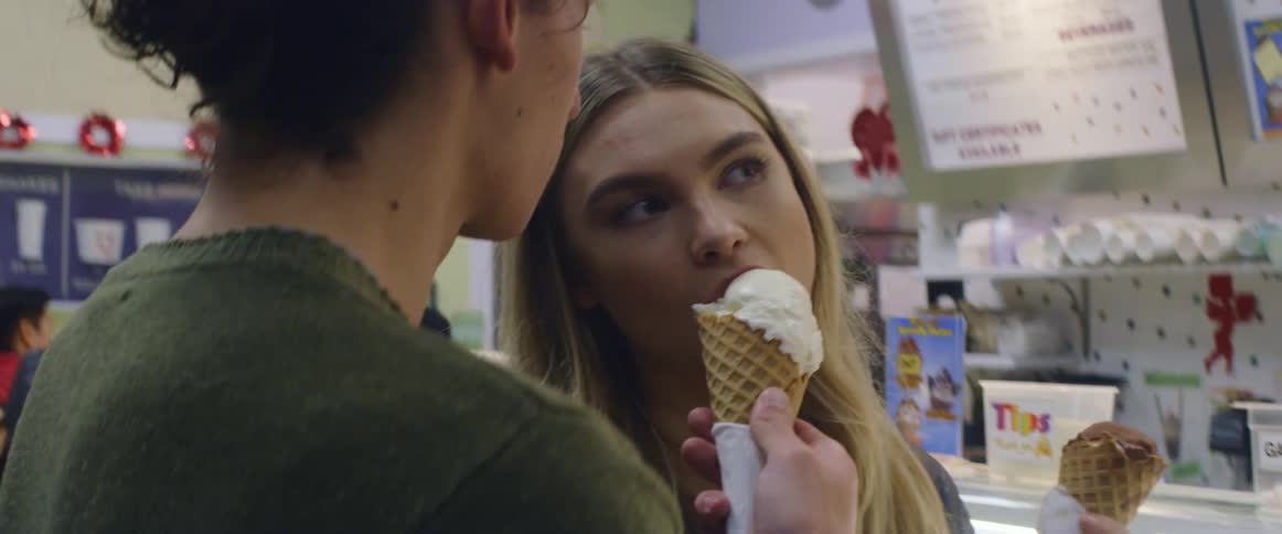 A man and woman share ice cream