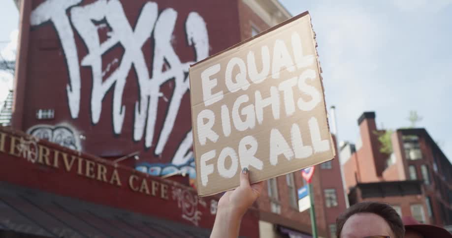 A man holding up a sign at a proteset