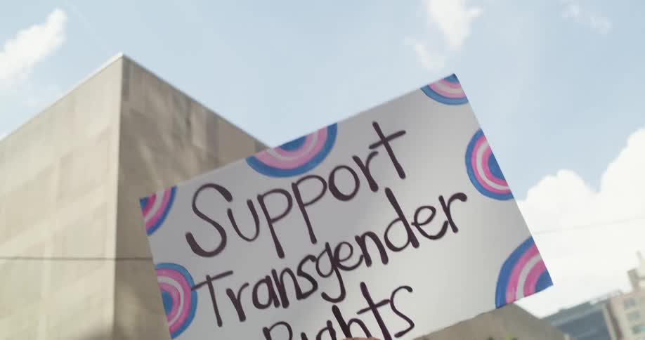 Woman holds a sign while participating in a protest