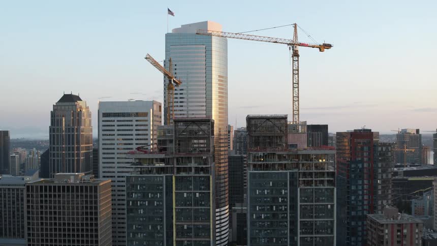 Slow push toward two new condo towers under construction in a large city