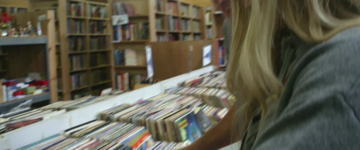 A man and woman browse through vinyl records in a store