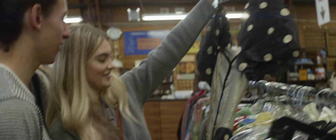 A man and woman are clothes shopping