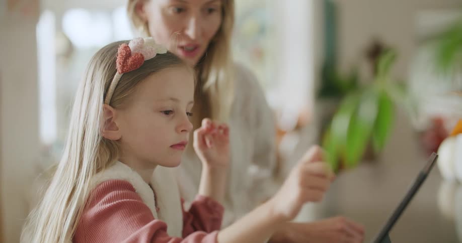 A mother and daughter using a tablet