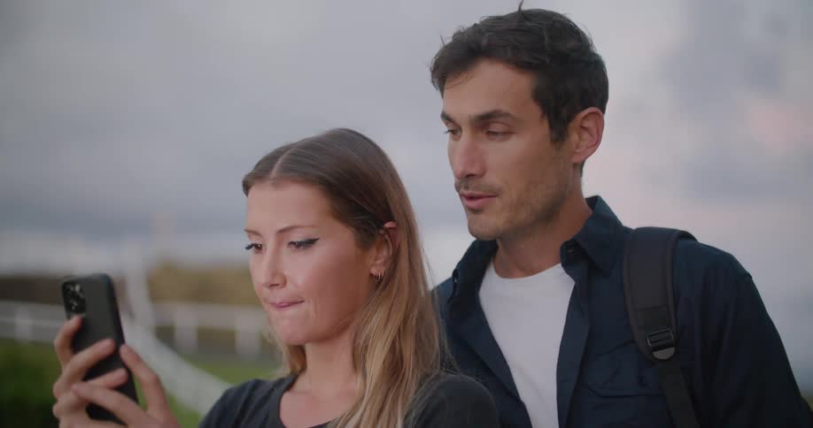 A man and woman talking on a smartphone