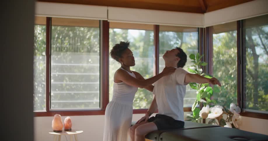 A woman working on massaging a man