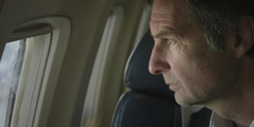 A man looks out of an airplane window