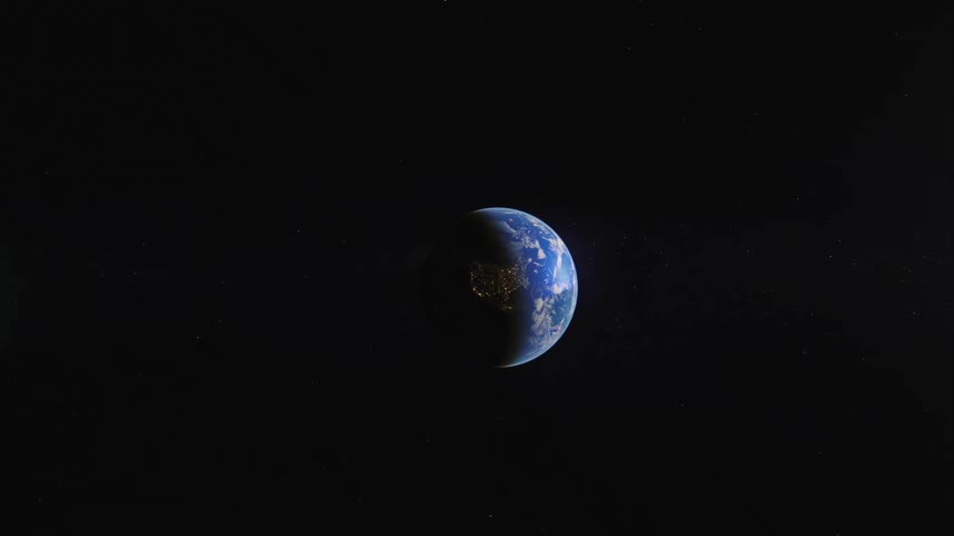 City lights are visible on earth as we zoom in on the planet