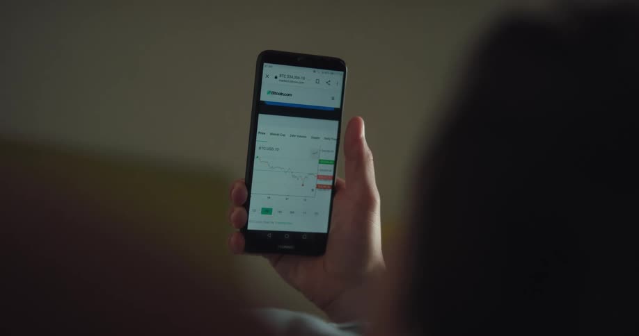 Person lying down on their back views mobile phone