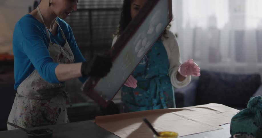 Two women are in a room and painting together