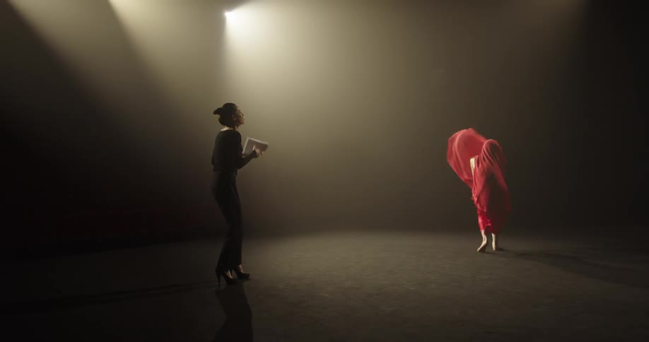 Two women are dancing on a stage together
