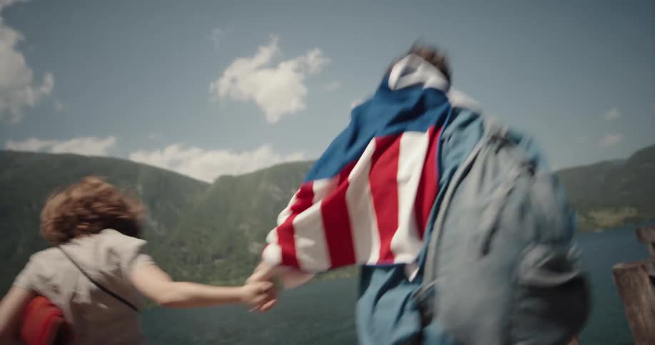 Two people running down a pier