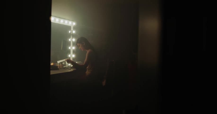 Woman sitting at mirror